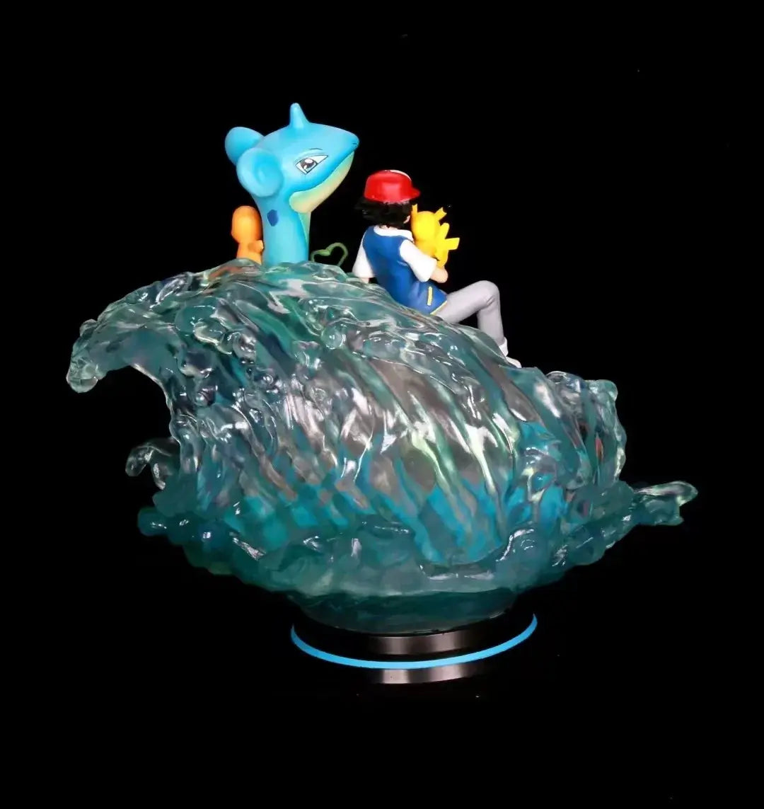 Pokemon action figure collectibles featuring Ash, Pikachu, and Lapras on a wave, detailed PVC figurines