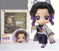 Nendoroid Shinobu 1655 model kit featuring the character with purple hair and accessories in front of its box.